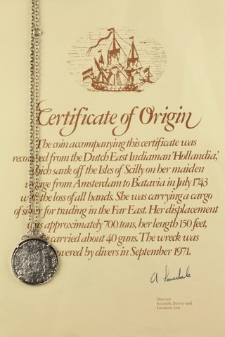 A silver coin mounted as a pendant, the mount inscribed "Treasure from Hollandia" sunk 1743, together with certificate 