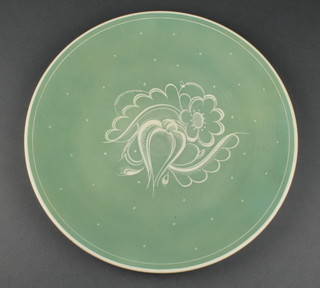 A Susie Cooper green glaze charger decorated with stylised flowers 14"