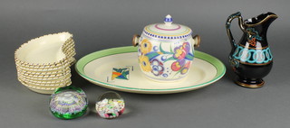 A circular cylindrical Poole Pottery biscuit barrel and cover 5" (cracked), a Clarice Cliff Dore pattern meat plate exclusively for Harrods 14 1/2", 9 Crown Ducal crescent shaped salad plates 7 1/2" (2 cracked), a Victorian jetware jug 7" and 2 paperweights 