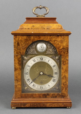 Kendal and Dent, a Queen Anne style bracket timepiece with arched gilt dial and silvered chapter ring, contained in a walnut case 
