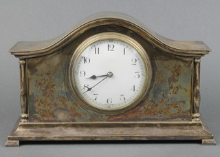 An Edwardian French bedroom timepiece with enamelled dial and Arabic numerals, contained in an arched silver plated case, raised on bracket feet 