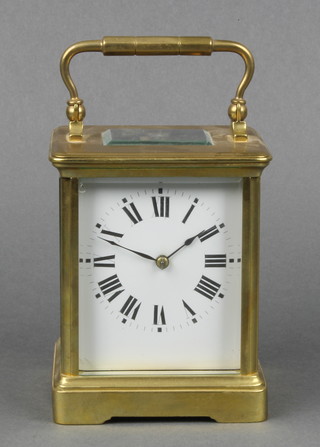 A 19th Century French 8 day striking carriage timepiece with enamelled dial and Roman numerals contained in a gilt metal case 