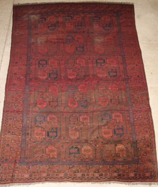 An Afghan carpet with 16 octagons to the centre, in wear, 155" x 102" 