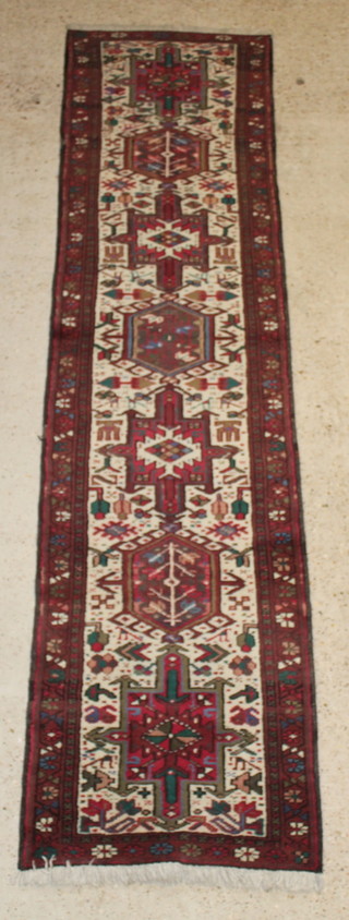 A Persian Karajeh brown and white ground runner with 11 medallions to the centre 119" x 28", slight wear to the side 