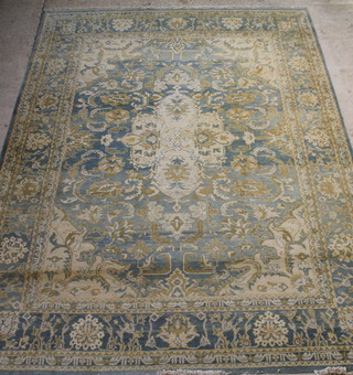 A blue and white Persian style rug with central medallion 145" x 107", some fading 