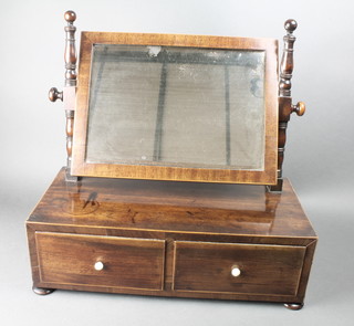 A Georgian rectangular plate dressing table mirror contained in a mahogany swing frame, raised on a rectangular base fitted 2 drawers with ivory turned handles, on bun feet 17"h x 18"w x 9"d