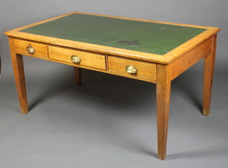 A George V Ministry of Works light oak writing table fitted 1 long and 2 short drawers with inset green leather writing surface, raised on square tapering supports 30"h x 59"w x 36" 