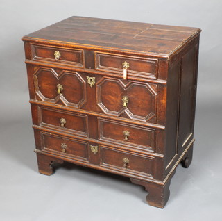 A 17th/18th Century oak chest of 4 long drawers with geometric mouldings and brass drop handles, raised on bracket feet 35"h x 33"w x 20 1/2"d 