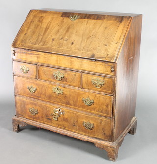 A Queen Anne style walnut bureau, the top with satinwood stringing, the fall front with quarter veneers revealing a well fitted interior with pigeon holes and well above 3 short and 2 long drawers, raised on bracket feet 40"h x 36"w x 20"d 