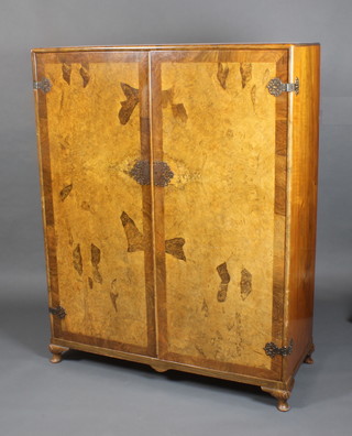 Heaton Tabb & Co. Ltd, a gentleman's Art Deco figured walnut wardrobe enclosed by a pair of crossbanded doors, the interior fitted hanging space and 6 drawers, raised on cabriole supports  59"h x 46 1/2"w x 19"d 