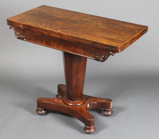 A William IV rosewood card table with carved apron, raised on a chamfered column with triform base, bun feet, 30"h x 36"w x 18"d 