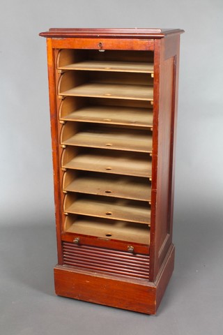 An Edwardian mahogany filing cabinet, the interior fitted trays enclosed by tambour shutter, the top fitted a reading rack 