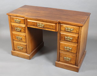 An Edwardian mahogany and walnut break front dressing table fitted 1 long drawer flanked by 8 short drawers with brass drop handles 31" x  48"w x 23"d  (the desk is in one section) 