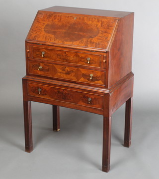 A 1930's Georgian style mahogany bureau of small proportions, the fall front revealing pigeon holes and and drawers above 3 long graduated drawers with pear drop handles, raised on square tapered supports 36"h x 22"w x 16"w 