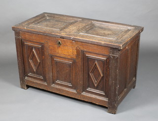 A 17th/18th Century oak coffer of panelled construction with hinged lid, the interior fitted a candle box with long iron hinges, 24"h x 31"w x 19 1/2"d 