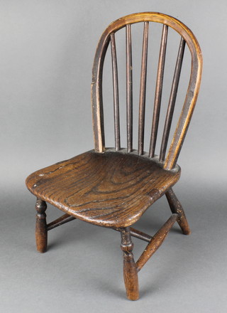 A 19th Century childs elm stick and hoop back Windsor chair, raised on turned supports with H framed stretcher (possibly reduced in height) 