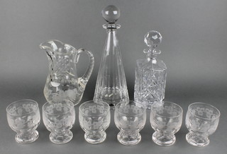 An etched and faceted glass ewer with vinery decoration and 6 ditto tumblers, a cut glass spirit decanter and a Villeroy and Boch mallet shaped decanter 