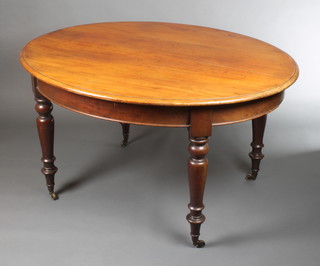 A Victorian oval mahogany dining table raised on turned supports 28"h x 51 1/2"w x 43"d 