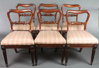A set of 6 William IV mahogany buckle back dining chairs with carved mid rails on turned and fluted supports with upholstered drop in seats 