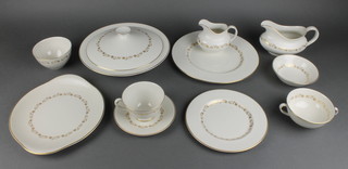 A 129 piece Royal Doulton Fairfax pattern dinner/tea service - 19 dinner plates, 6 soup bowls, 13 breakfast plates, 18 side plates, 21 tea plates (1 cracked 3 have rubbing to the gilding), 9 pudding bowls, 2 tureens and covers, bread plate, 2 sauce boats, cream jug, sugar bowl, 12 tea cups and saucers, 6 twin handled soup bowls and saucers 