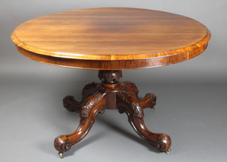 A Victorian rosewood circular snap top dining table, raised on carved turned column and tripod base 28"h x 49 1/2"diam. 