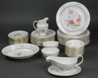 A Royal Doulton Kismet pattern dinner service comprising 11 dessert bowls, 2 sugar bowls, 14 small plates, 14 medium plates, a sauceboat and stand, a milk jug, oval dish and 14 dinner plates
 