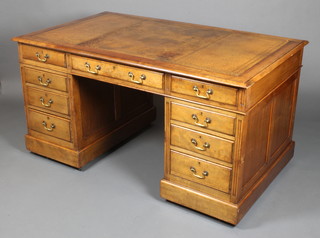 An Edwardian mahogany desk with brown leather inset writing surface, having column decoration to the sides, fitted 1 long and 8 short drawers with brass swan neck drop handles and escutcheons, 38"h x 60"w x 36"d  