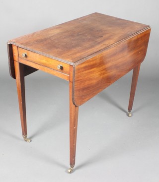 A Georgian mahogany Pembroke table fitted a drawer, raised on square tapered supports ending in brass caps and castors 28"h x 33"w x 17" when closed by 36" when open 