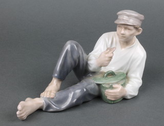 A Royal Copenhagen figure of a reclining fisherman eating a biscuit 865 7 1/2" 