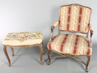 A 19th Century style French open arm salon chair upholstered in Berlin wool work material with X framed stretcher, raised on cabriole supports together with a rectangular carved stool, the seat upholstered in Berlin woolwork 