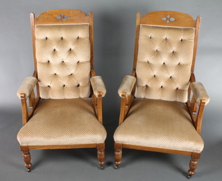 A pair of Edwardian Art Nouveau carved oak show frame armchairs upholstered in brown buttoned Dralon on turned supports (frames are loose) 