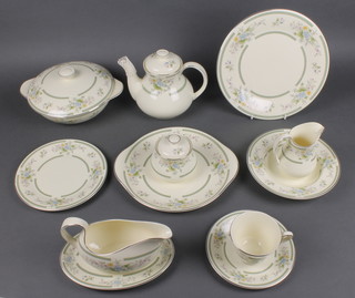 A Royal Doulton Romance collection Adrienne pattern part tea and dinner service comprising 5 tea cups, 6 saucers, tea pot, 6 small plates, 6 medium plates, 6 dinner plates, 2 tureens and lids, a sandwich plate, milk jug, sugar bowl and lid, sauce boat and stand and 6 dessert bowls 