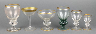 A quantity of gilt decorated table glassware comprising 10 liqueurs, 12 sherries, 6 wines, 10 champagnes and 18 cocktails together with 10 green glass ditto 