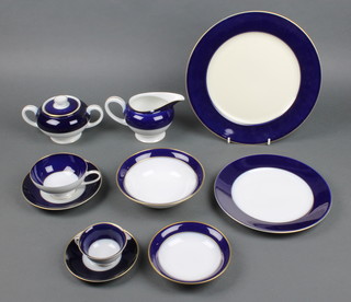 A Rosenthal blue and gilt rimmed tea and dinner service comprising 1 coffee cup, 1 saucer, 6 tea cups, 8 saucers, 5 side plates, 7 dinner plates, 6 saucers, 8 dessert bowls, a milk jug, sugar bowl and lid 