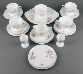 A Shelley Art Deco Wild Flowers pattern tea set comprising 4 tea cups, 1 cream jug, 1 sugar bowl, 6 saucers, 6 plates and a sandwich plate together with 2 egg cups  
