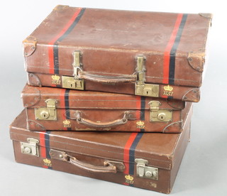 A Revelation brown leather suitcase with brass mounts 7" x 24" x 15" and 1 other brown leather suitcase with brass mounts 6" x 22" x 14" and 1other with chrome mounts 7" x 24" x 7", all with blue and white stripe and marked with a crown above HKT 