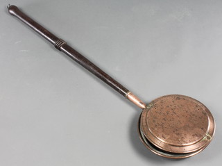 A copper warming pan with turned oak handle 