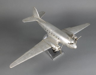 A metal model of a Douglas DC3 Dakota in flight, base marked AM2011 no.8062,  25"