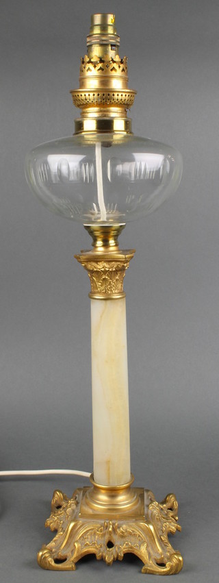 A Victorian glass onyx and gilt metal oil lamp, converted to an electric table lamp raised on rococo style feet 19" 