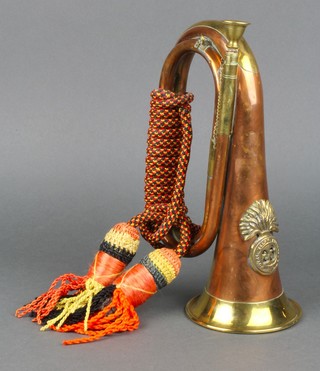 A reproduction copper and brass bugle marked 23rd Royal Welsh Fusiliers 
