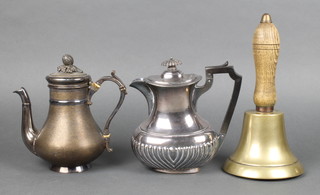 A brass hand bell with turned wooden handle, a Britannia metal hotwater jug and a silver plated coffee pot 