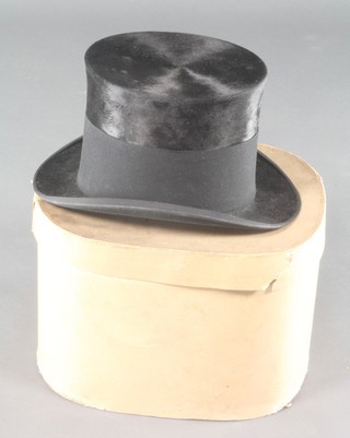 A gentleman's English House black silk top hat, complete with cardboard hat box 