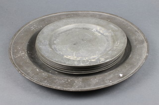 An 18th Century circular pewter charger the reverse with London Touch mark 15" together with 8 pewter plates, marked EPS, 9 1/2" diam.