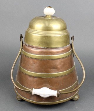 A Dutch copper and brass dome shaped peat/coal bucket with ceramic handle, raised on bun feet 13" 