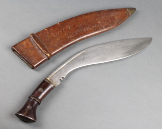 A Military issue Kukri, the 13 1/2" blade marked II G 192 35, the leather sheath marked A.A 1940 Mareth Line 1943 