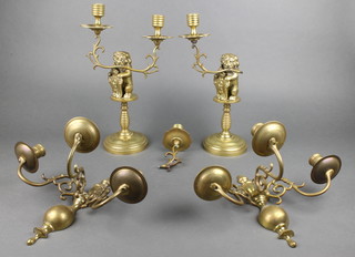 A pair of Dutch style brass 3 light wall sconces 9" and a pair of twin light candelabrum supported by rampant lions 15" (1f)