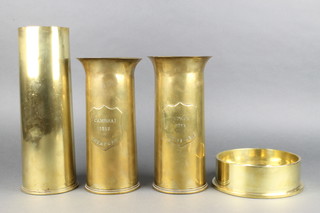 A pair of Trench Art vases formed from 18lb shell cases marked Ypres and Cambrai 1917 together with a 25lb shell case dated 1943 and 1 other shell case formed into an ashtray dated 1959 