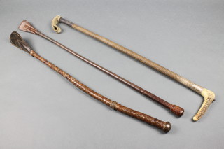A hunting crop with silver band and swag horn handle by Swaine & Co., a hunting whip by Swaine Adeney and 1 other whip  