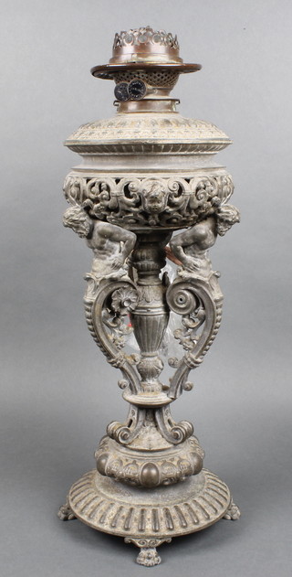 A Victorian pierced metal oil lamp, the base supported by 3 figures complete with glass reservoir (f) 20"