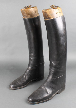 A pair of black leather riding boots, complete with wooden boot trees marked Rowell & Sons Melton Mowbray 
